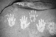 Ancestral Puebloan handprints on a cliff face - Photo by Wayne Ranney